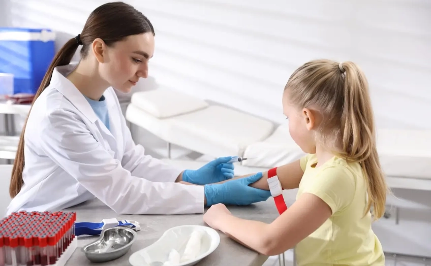 Nurse taking a blood sample from a child